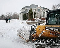 Blizzard dumps snow on flooded North Dakota