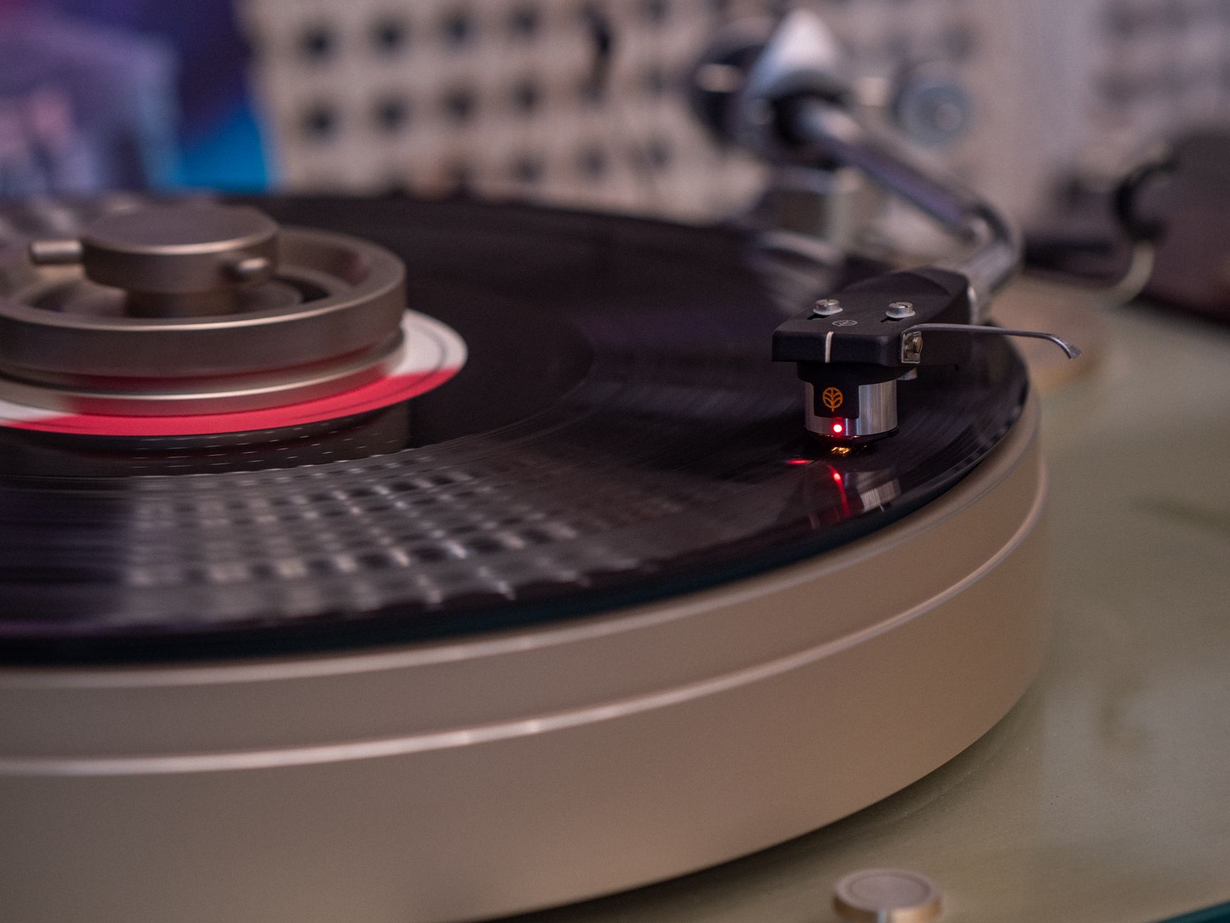 The Voyager Golden Record carries a small sample of uranium on its cover, placed there so that whoever finds it can measure the decay and work out how long it has been drifting — a built-in clock for a message engineered to last around a billion years.